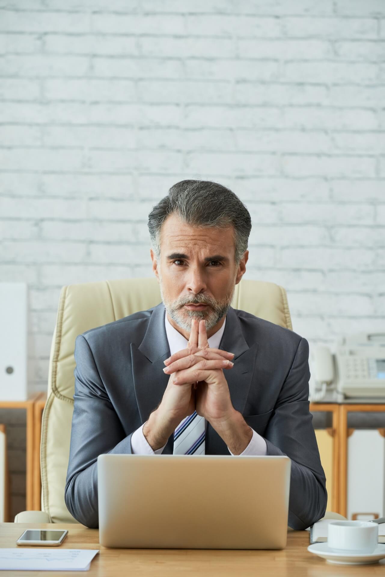 Executive Search 1 Experienced business executive representing leadership recruitment, sitting in an office with a thoughtful expression.